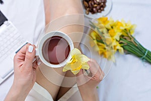 Woman having a cup of tea in bed