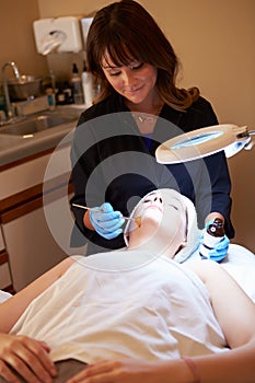 Woman Having Dermo Abrasion Cosmetic Treatment At Spa