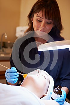 Woman Having Dermo Abrasion Cosmetic Treatment At Spa photo