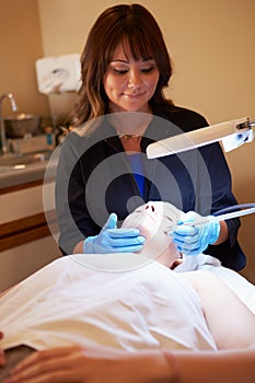 Woman Having Dermo Abrasion Cosmetic Treatment At Spa photo