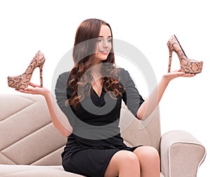 Woman having difficult choice between shoes