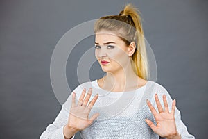 Woman deny something showing stop gesture with hands