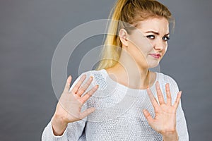 Woman deny something showing stop gesture with hands