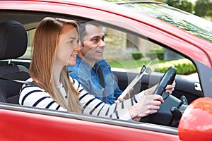 Woman Having Driving Lesson With Instructor