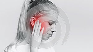 Woman having ear pain, touching her painful head
