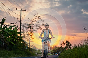 Woman having an excursion on her bike in tropical vacation