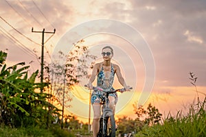 Woman having an excursion on her bike in tropical vacation