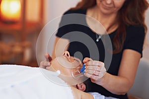 Woman having a face cupping massage in salon