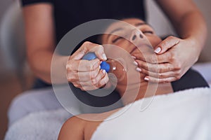 Woman having a face cupping massage in salon