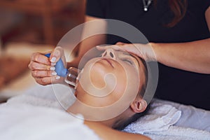 Woman having a face cupping massage in salon