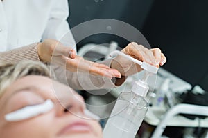 Woman having facial and eyebags treatment