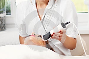 Woman having facial peeling in beauty salon