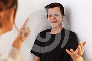 Woman having a fight with her teenager son - gesturing and expressing disagreement