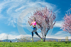 Woman having fitness run in the spring sun