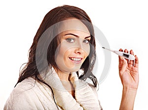 Woman having flue taking thermometer.