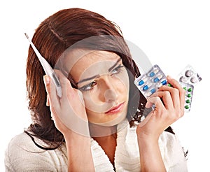 Woman having flue taking thermometer.