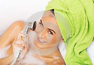 Woman having fun with showerhead
