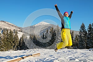 Woman having fun in winter mountains
