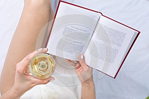 Woman having a glass of wine in bed