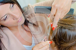 Woman having hair cut