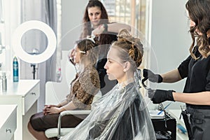 Woman having hair foiled while coloring in hair salon