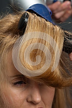 Woman having hair styled