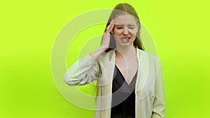 Woman having headache crying in space studio