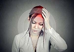 Woman having a headache with her head in her hand photo