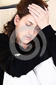 Woman having headache at home