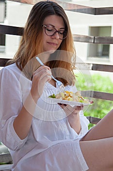 Woman having a healthy meal on a patio