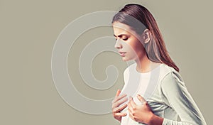 Woman having heart attack. Heart attack concept. Girl feeling heart pain and holding her chest. Healthcare and medical