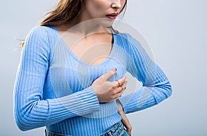 Woman having heart attack. Heart attack concept. Girl feeling heart pain and holding her chest. Healthcare and medical