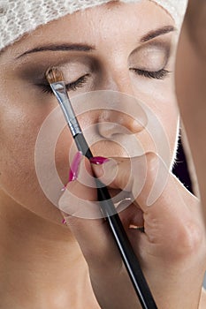 Woman having her makeup applied