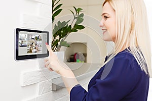 Woman having a Home automation control station in a modern home 3D render