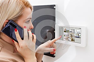 Woman having a Home automation control station in a modern home 3D render