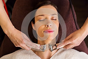 Woman having hydradermie facial treatment in spa