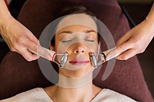 Woman having hydradermie facial treatment in spa