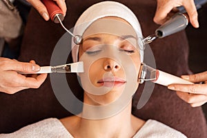 Woman having hydradermie facial treatment in spa photo