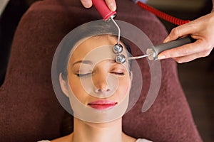 Woman having hydradermie facial treatment in spa photo