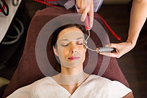 Woman having hydradermie facial treatment in spa photo