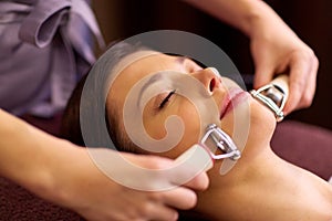 Woman having hydradermie facial treatment in spa photo