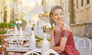 woman having italian coffee at the cafe on the street in Toscana city. Soft focus with small depth of field photo