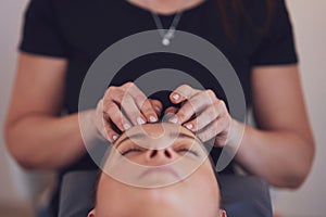 Woman having japan style face massage in salon