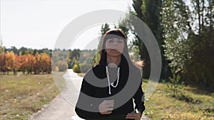 Woman having jog training in autumn park