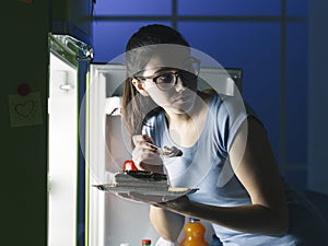 Woman having a late night snack photo