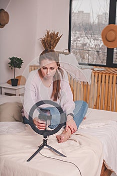 Woman having live stream on cellphone at home