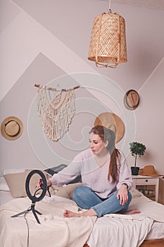 Woman having live stream on cellphone at home