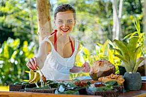 Woman having lunch in tropical setting during her vacation