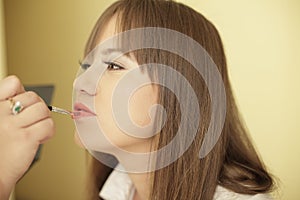 Woman having make up applied