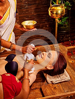 Woman having massage with pouch of rice